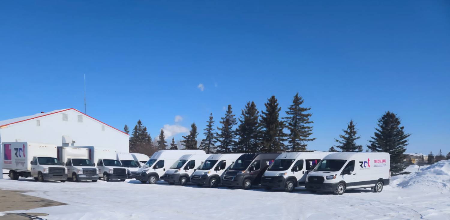 RCT cube vans and cargo vans lined up at the Grande Prairie yard.